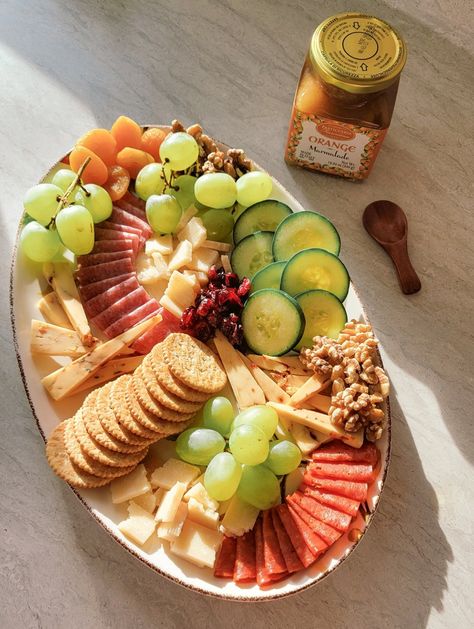 A small, green and red charcuterie board perfect for the holidays. Includes salami pepperoni parmesan gruyere grapes cucumber apricots walnuts cranberries. aesthetic charcuterie board on oval plate. Decorative tray. Aesthetic charcuterie board. Red Charcuterie Board, Cranberries Aesthetic, Aesthetic Charcuterie Board, Aesthetic Charcuterie, Tray Aesthetic, Small Charcuterie Board, Scientific Art, Oval Plate, Snack Board