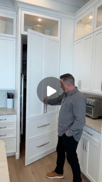 Quality Cabinet Refacing, Inc. on Instagram: "Check out this amazing kitchen we just completed in Palm Harbor, FL! At first glance, it looks like a typical setup – ovens, a sleek hood, and beautiful cabinets. But behind those doors is a hidden pantry that maximizes space while keeping the kitchen looking clean and modern. I love bringing together style and functionality! Let me know what you think! 

Give us a call at 727-799-5220!" Disappearing Cabinet Doors, Corner Kitchen Pantry Cabinet Built Ins, Kitchen Cabinet Above Fridge, Drop Down Kitchen Cabinets, L Shape Pantry Cabinet, Hidden Door In Kitchen Cabinet, Wall To Ceiling Kitchen Cabinets, Cabinet Pantry Next To Fridge, Hidden Door Kitchen Cabinets