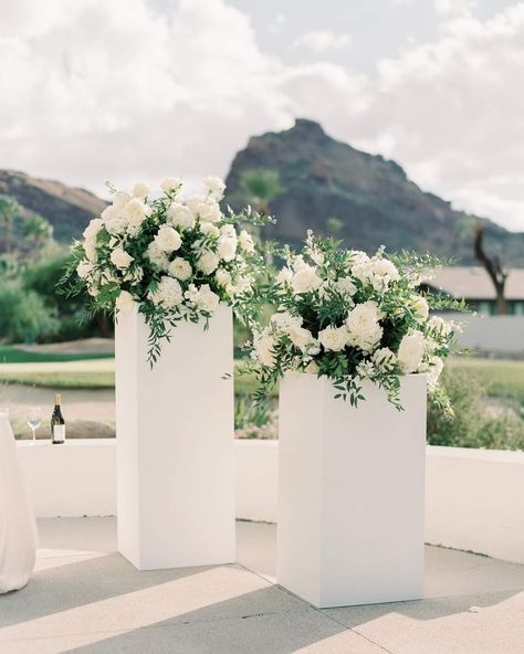 Wedding Podium Flowers, Floral Statement Pieces Wedding, Ceremony Flowers On Pedestals, All White Ceremony Wedding, White Pedestal Wedding, Wedding Backdrop Alter, Pillar Flowers Wedding Ceremony, Wedding Pedestals Ceremony, Planters Wedding Ceremony