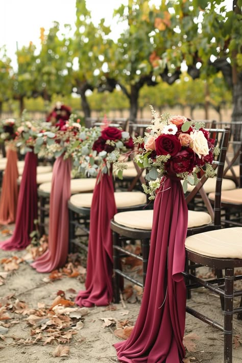 Walk down the aisle surrounded by nature's bounty 🍇. This vineyard wedding captures the essence of romance with stylish wine-colored accents amidst lush grapevines and rustic barrels. Say 'I do' in a setting where love and wine flow endlessly 🍷💍. #WeddingInspiration #VineyardWedding #WeddingDecor #RomanticWeddings #RusticChic #OutdoorWeddings #WeddingIdeas #DreamWedding Burgundy And Navy Wedding Aisle Decor, Burgundy Chair Sashes, Red Wedding Chairs, Burgundy Ceremony Decor, Romantic Marsala Wedding, Burgundy Wedding Ceremony Decor, Burgandy Wedding Themes Fall, Fall Wedding Aisle Decorations Outdoor, Burgundy Wedding Aisle