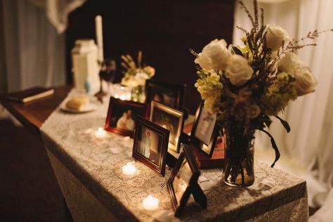 A memorial table at the altar with pictures of loved ones who have passed away Memorial Altar, Altar Ideas For Passed Loved Ones, Wedding Rip Table, Alter For Passed Loved One, Wedding People Who Have Passed Memory Table, Candle For Loved Ones Lost Wedding, Candle Burning For Loved One At Wedding, Memory Table, Wedding Altars