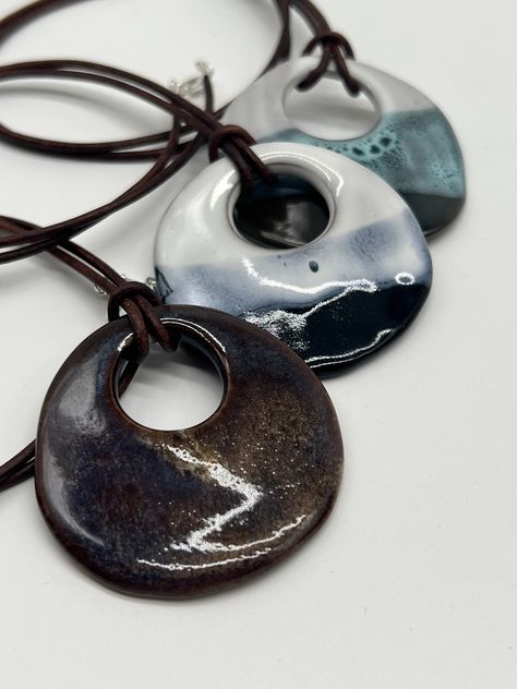 "This pendant is the perfect compliment to your favorite outfit. whether you are looking for a bold pop or a subtle compliment, these ceramic pendants are the perfect accessories to add to your collection! Handmade in Longmont, CO.  2 inch pendant on a 20\", 24\", or 27\" leather cord." Ceramics Pendant, Pottery Pendants, Ceramic Accessories, Clay Carving, How To Make Ceramic, Pottery Necklace, Ceramic Bead Jewelry, Ceramic Pendants, Handmade Ceramic Jewelry