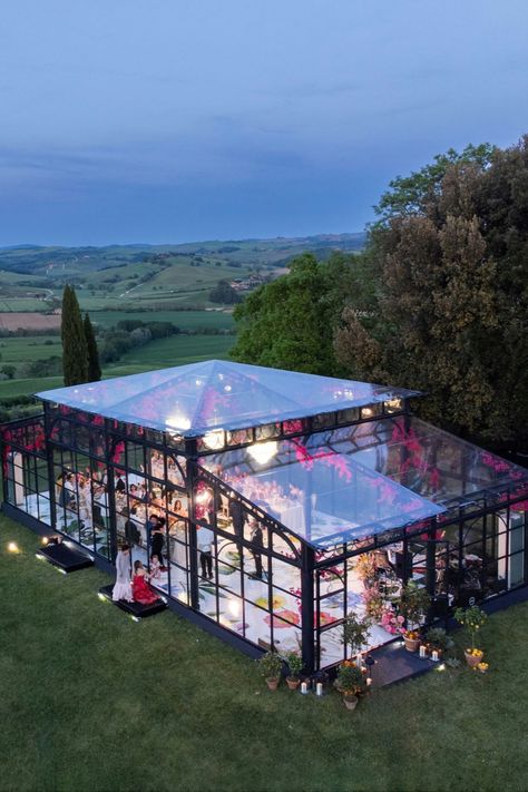 Enchanting evening at a glasshouse wedding venue surrounded by rolling hills. The perfect backdrop for a magical celebration, blending nature’s beauty with elegant architecture #glasshousewedding #weddingvenue #outdoorwedding #luxurywedding #weddinginspiration #romanticwedding #destinationwedding #chicwedding #countrysidewedding Outdoor Wedding Aisle Ideas, Garden Wedding Aisle, Aisle Flowers Wedding, Wedding Aisle Ideas, Wedding Ceremony Backdrops, Outdoor Wedding Aisle, Aisle Decor Wedding, Glasshouse Wedding, Wedding Aisle Decoration