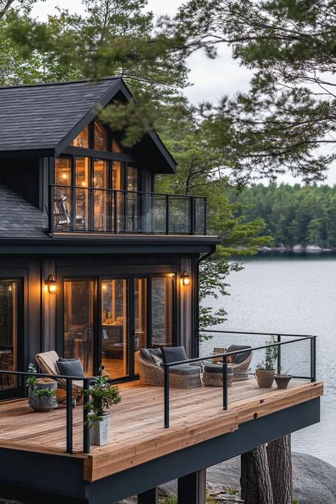 Rustic modern lake house facade with wraparound timber porch stunning Scandinavian lake view. Check out all of these charming and cozy rustic lake houses that perfectly blend with nature for the ultimate peaceful retreat. Lake Mountain House, Building A Lake House, Chalet Lake House, Exterior Lake House Ideas, Cozy Lake House Exterior, Lake House Decks And Patios, Big House Design Exterior, Lake House Screened In Porch, Minimalist Lake House