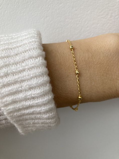 This beautiful little bracelets is perfect for a minimalist look! It is available in both gold and rose gold-filled. D E T A I L S  *18k Gold filled/Rose gold filled satellite chain - 1.6mm curb with 2.7mm ball  *Gold fill is a wonderful alternative to real gold and unlike gold plating does not rub off.  *Hall marked gold filled spring ring clasp closure. S I Z I N G *  H E L P Choose the length from the drop down menu. Use the length guide as a reference. If unsure about the size you need  choose the EXTENDER option . C A R E * T I P This is a dainty bracelet so please treat it with care. To maintain it in great condition avoid contact with water, perfume and harsh chemicals.  Also remove when exercising, sleeping and doing housework in case it snags. P A C K A G I N G All our products ar Water Perfume, Bracelet Rose Gold, Bracelet Stacking, Bracelet Minimalist, Dainty Bracelet, Minimalist Bracelet, Dainty Bracelets, Bracelet Gold, Gold Filled Chain