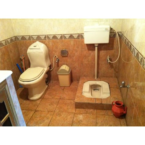 Two toilets in a middle-class Pakistani home, 2012.  One commode and one Persian-style squat toilet. Red pitcher on right is for washing oneself.  On left the commode has a sprayer. Pakistani Bathroom Designs, Indian Toilet Design, Commode Toilet Design, Indian Bathroom Interior Design, Indian Toilet, Class Bathroom, Latest Bathroom Tiles Design, Latest Bathroom Tiles, Squat Toilet