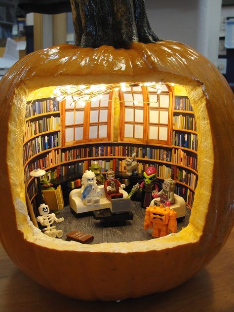 photo of a pumpkin with a large opening carved in the front to reveal a tiny library with shelves of books a large window in the back and Lego characters enjoying the space Truro Massachusetts, Pumpkin Diorama, Pumpkin Carving Designs, Pumpkin Contest, Library Display, Halloween Pumpkins Carvings, Pumpkin Carving Ideas, Truro, Library Displays