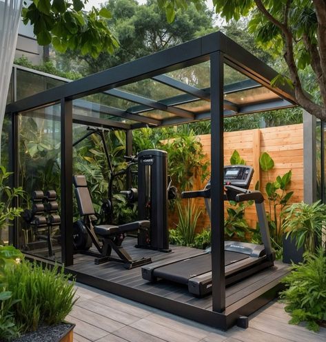 Experience the perfect blend of nature and fitness with this modern outdoor gym! Set in a lush garden, this sleek gym features a glass roof and black metal frame, equipped with top-of-the-line fitness gear including a treadmill, weight bench, and a multifunctional training machine. Surrounded by vibrant greenery, this serene and invigorating space is ideal for those who love to...#Training #Building #and #Muscle #Fitness #NutritionTips #Enhancing #Strength #HealthyLiving #HealthTips #SelfCare Outdoor Gyms Ideas, Gym In Garden, Garden Shed Gym, Outside Gym Ideas, Outside Home Gym, Gym At Home Design, Outside Gym Ideas Backyards, Home Gym Shed Ideas, Garden Gym Outdoor