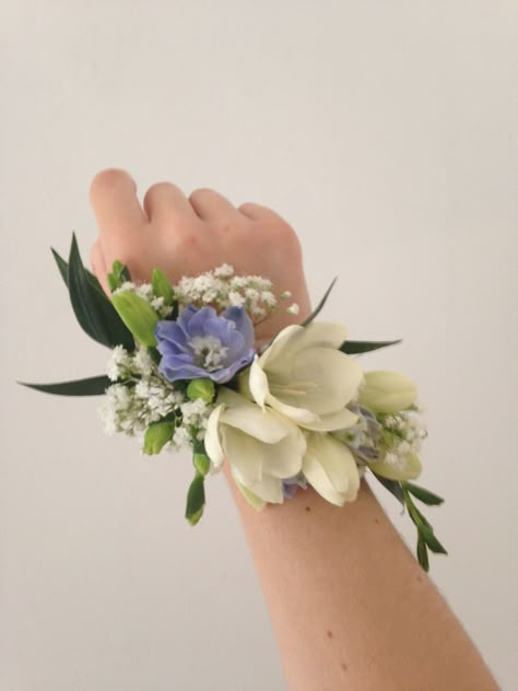 Pretty wrist corsage of Freesia and Delphinium Flower Bracelet For Prom, Natural Corsage Prom, Floral Corsage Wrist, Formal Corsage Wristlets, Wristlet Corsage Prom, Periwinkle Corsage Prom, Prom Hand Flowers Wrist Corsage, Forget Me Not Corsage, Prom Corsage Trends 2024