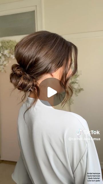 Kristina Youssef - K Y K ® on Instagram: "California stylist @rachel.luskhmua shares how to create a stunning textured clean bun using cult favourite @kykhaircare Magic dust volume powder.   Use the powder to add volume at the crown before back combing, and use it to add texture and fullness before pinching on the hair.  Add it from roots to ends to create the perfect texture in your fringe for facial framing." Low Loose Updo Wedding Bridesmaid Hair, Hair Bun Low Tutorial, Easy Low Bun For Wedding Guest, Soft Loose Updo, Higher Updos, Evening Hair Updos, Bun With Loose Strands, Low Bun For Shoulder Length Hair, Low Bun With Face Framing Pieces