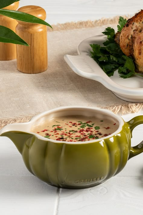 Homemade gravy might seem intimidating to make, but this streamlined recipe for classic peppercorn sauce is simple and relatively straightforward. Also known as the classic French sauce ‘au poivre’, it’s the perfect accompaniment to holiday turkey and roast beef. Present it tableside in a Pumpkin Gravy Boat garnished with fruity, colorful pink peppercorns for elegant fall and holiday entertaining – the stoneware will keep the sauce warm for serving.  Recipe on our website! Peppercorn Gravy, Tailgate Appetizers, Kitchen Decor Fall, Sauce Au Poivre, Thanksgiving Gravy, French Sauces, Peppercorn Sauce, Pink Peppercorn, Le Creuset Cookware