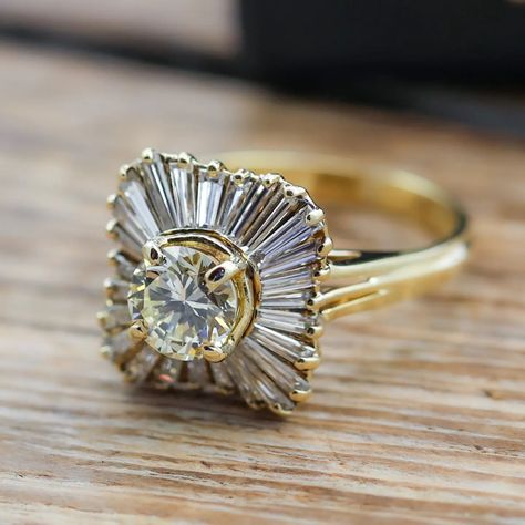 This ring centers a round brilliant cut diamond (1.05ct apx, N-O, VS2) set in 18k yellow gold with a halo of 26 tapered baguette cut diamonds (1.00ctw apx, K-L, VS) – sku: 130-08695 . . . . . . . #vintagejewelry #diamondring #engagementring #showmeyourrings #theknotrings Gemstone Engagement, Baguette Cut Diamond, Baguette Cut, Round Brilliant Cut Diamond, Round Brilliant Cut, Brilliant Cut Diamond, Round Brilliant, Diamond Cuts, Diamond Ring