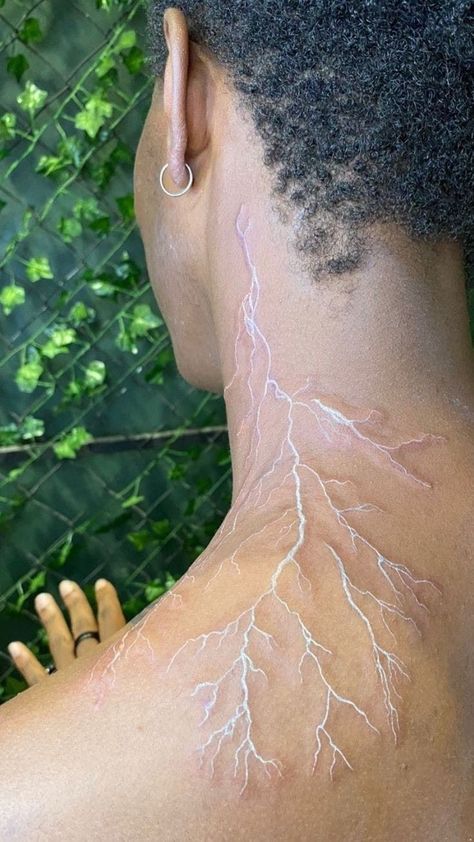 Lightning Marks On Skin, Lighting Tatoos Men, Red Veins Tattoo, White Ink Tattoos On Dark Skin, Lightning Spine Tattoos For Women, White Tattoo Black Skin, Red Vein Tattoo, White Tattoo Lightning, Lightening Tattoo On Shoulder