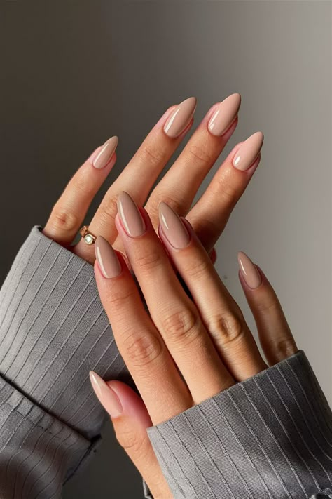 Discover the elegance of simplicity with these simple nail ideas that celebrate neutral plain colors. A soft beige base with a delicate matte finish brings a subtle sophistication to your manicure, perfect for any occasion. Enhance the look with a touch of minimalist nail art, like a tiny gold dot on each accent nail. This chic style is not only trendy but also incredibly easy to DIY at home! Grab your tools and start creating! #SimpleNailIdeas #NeutralNails #ChicManicure Classy Nails Neutral, Gel X Nails Almond Neutral, Nails Fresh, Soft Colors Nails Design, Simple But Chic Nails, Neutral Bridal Nails Wedding, Almond Nail Neutral Colors, Nail Colors Solid, Wedding Season Nails