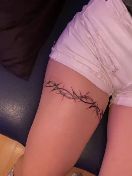 35 Best Barbed Wire Tattoos For Men And Women - Tattoo Pro Tattoo That Wraps Around Leg, Barb Tattoo Wire, Barb Wire Tattoo Around Thigh, Leg Bands Tattoo, Arm Tattoos Wrap Around, Barbed Wire Wrap Tattoo, Thigh Tattoos Wrap Around, Tattoos Wrapped Around Leg, Barbed Wire Wrapped Around Arm Tattoo