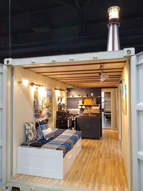 Here is a great view of a Tiny House Container. The IKEA bed has storage underneath and can be pulled out to accommodate two people. The IKEA bed is also on rollers and can be rotated to fit between the two doors. Great for stargazing when you leave the big doors open. There is a kitchenette with oven and four burners, and a double farm sink against the inside wall. At the backside of the wall is an oversized bathroom with shower and flushing toilet. It all fits in a 20ft shipping container. Tiny House Container, Shipping Container Interior, Container House Interior, 20ft Shipping Container, Shipping Container Cabin, Container Conversions, Storage Container Homes, Container Cabin, Shipping Container House Plans