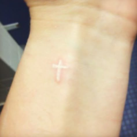 Small White Ink Cross Tattoo On Wrist Small White Ink Tattoo For Women, White Ink Cross Tattoo, Small White Tattoo For Women, Tiny White Ink Tattoo, Small White Ink Tattoo, White Cross Tattoo, Heart And Cross Tattoo, White Ink Tattoo Ideas, White Wrist Tattoos