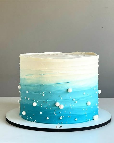 11. Blue Ombre Ruffle Cake When you start planning any party, you want to be creative—whether it is your decoration, dress, dessert or a cake idea. You will want the party pleasurable for everyone. Sea Theme Cake Ocean, Simple Ocean Theme Cake, Ocean Cake Ideas Simple, Simple Ocean Cake, Ocean Cake Birthday, Ocean Sheet Cake, Sea Cake Design, Simple Cute Cakes, Sea Cakes Birthday