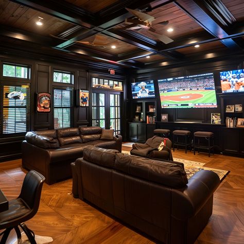 Ultimate man cave featuring luxurious black leather couches, dark wood paneling, and wood floors. Equipped with big screen TVs playing baseball, a bar with stools overlooking a scenic view, and cozy high ceilings. Perfect for sports fans with a minimalist, masculine design, this space includes an island bar for entertainment and built-in cabinets for storage. Man Cave Tv Setup, Man Cave Minimalistic, Man Basement Ideas, Man Cave Movie Room, Moody Sports Basement, Man Cave Theater Room, Men’s Lounge, Cozy Rec Room, Basement Whiskey Lounge