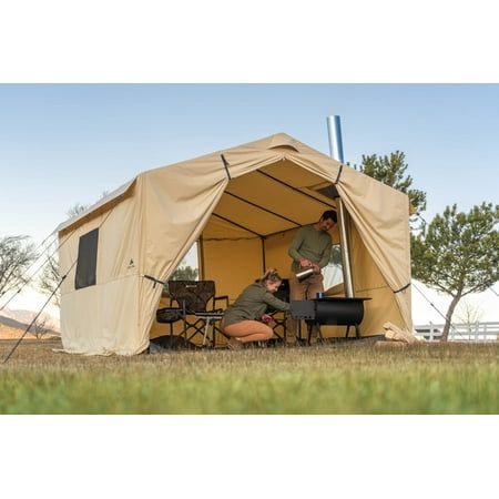 Get this Ozark Trail North Fork 12' x 10' Wall Tent for your outside exploring needs. It is convenient whether there's rain, sleet or snow. The canvas-imitation fabric on this wall tent with a stove jack wraps around a frame with adjustable legs and eaves to place it on uneven ground. Setup is easy with the color-coded poles and hubs, while a removable PVC floor keeps you dry from underneath. Fit your heat source in the outdoor tent, with its integrated section that fits pipes up to 5" in diamet Tent Kitchen, Hot Tent Camping, 12 Person Tent, Campsite Setup, Tent With Stove, Canvas Wall Tent, Window Storage, Survival Tent, Hot Tent