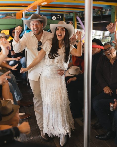 Couple in Chiva Bus | Colombian Wedding Tradition Description: Bride and groom celebrating in a chiva bus, Colombian wedding traditions, pre-wedding celebration, Paisa party in Colombia, destination wedding moments, fun-filled wedding activities 🚍🎶🎉 Colombian Wedding Ideas, Travel Wedding Theme Decoration, Wedding Locations Beach, Destination Wedding Attire, Outdoor Ceremony Ideas, Colombian Wedding, Colombia Wedding, Scenic Wedding, Cultural Wedding