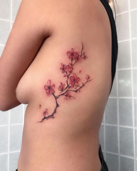 70 Cherry Blossom Tattoo Designs And Ideas To Try In 2023 Blooming Tattoo Ideas, Red Blossom Tattoo, Hummingbird Cherry Blossom Tattoo, Mugunghwa Flower Tattoo, Cherry Blossom Tattoo Thigh, Back Cherry Blossom Tattoo, Side Of Back Tattoo Women, Cherry Blossom Tattoo On Black Women, Cherry Blossom Tattoo Aesthetic