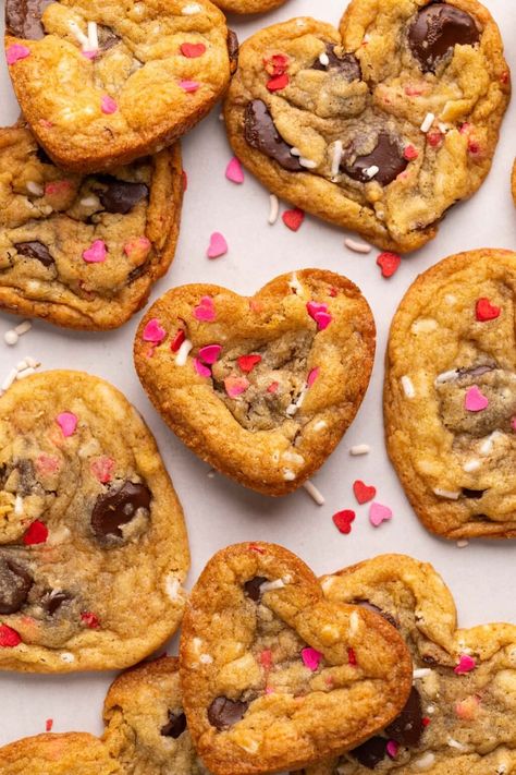 These easy Heart Shaped Chocolate Chip Cookies have 10 minute prep time. Just add red and pink sprinkles for a fun Valentine’s Day Cookie! Valentines Choc Chip Cookies, Peanut Butter Cookies Heart Shaped, Heart Shaped Valentine Cookies, Red Chocolate Chip Cookies, Baking Ideas Valentines Day, Heart Shape Chocolate Chip Cookies, Heart Shaped Shortbread Cookies, Valentine’s Day Chocolate Chip Cookies, Strawberry Heart Cookies