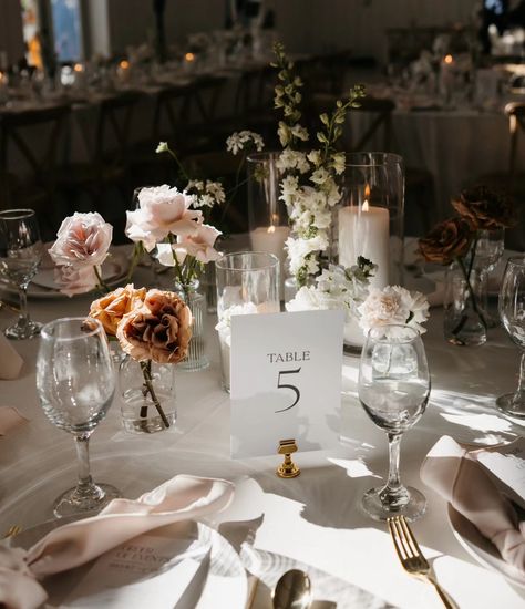 The dreamiest of bud vase centerpieces 😍 I can't get over the magic that @medaabigailphotography made with this table and that lighting. ✨ It just needed a permanent place on our feed. All White Bud Vases Wedding, Single Stem Floral Centerpieces, Bud Vase Aisle Decor, Wedding Table Decorations With Candles, Wedding Centerpiece With Pictures, Bud Vase Table Setting, Flower Petal Centerpieces, Wedding Bud Vases Centerpiece, Round Table Candle Centerpieces