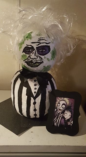 I decided to go with Beetlejuice for the Pumpkin contest at work (used: 2 white pumpkins, black, white, purple, yellow and lime green paint on the pumpkin. Used a cheap white costume wig for hair -cut, teased, sprayed with rave to make it stiff. Used a cheap faux leather hair-bow glued on an alligator clip. Most of the items I found at Michael's on the 70 % off isle). I won 1st place. So glad I decided to do this one! I looked thru cartoon images of him for the inspiration for his face. Beetle Juice Pumpkin Painting Ideas, Beetlejuice Painted Pumpkin, Beetlejuice Pumpkin Painting Ideas, Beetle Juice Pumpkin Painting, Beetlejuice Pumpkin Painting, Beetle Juice Pumpkin, Beetlejuice Pumpkin Carving, Beetlejuice Pumpkin, Lime Green Paint