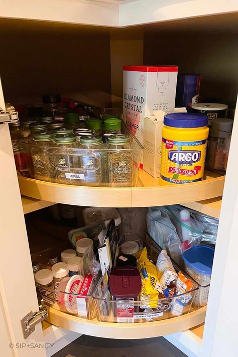 Organize your spices in a lazy susan cabinet for easy access, efficiency, and to make the most of your dried herbs and spices. Check out the steps, considerations and space saving methods to create your own well organized storage space. Spin Cabinet Organization, Spice Cabinet Lazy Susan, Dry Herb Storage Ideas, Spice Organization Lazy Susan Corner Cabinets, Spice Organization Corner Cabinet, Spice Organization Lazy Susan, What To Put In A Lazy Susan Cabinet, Organizing Lazy Susan Cabinet Kitchens, How To Organize Corner Kitchen Cabinet Lazy Susan