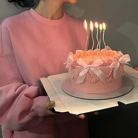 A girl in a pink hoodie holding her birthday pink cake with ribbons and silver candles :) Pinterest Cakes Birthday, Ribbon Birthday Cake, Pastel Pink Cake Aesthetic, Small Pink Cake, Pink Birthday Cake Aesthetic, Elegant Pink Cake, Pink Mini Cake, Pink Ribbon Cake, Pink Cake Aesthetic