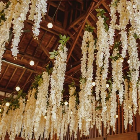 Hanging Flowers At Wedding, Hanging Wisteria Wedding Diy, Floating Florals Wedding, Hanging Wedding Decorations Ceilings, Hanging Flowers Wedding Reception, Hanging Lights Wedding Reception, Ceiling Flowers Wedding, Barn Reception Decorations, Fake Flower Garland