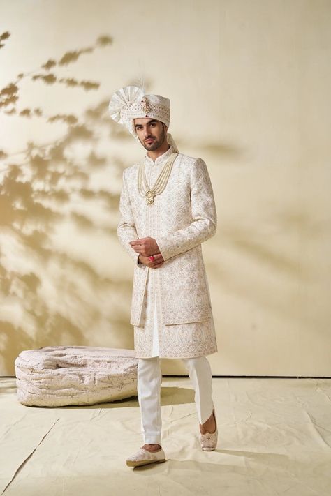 Step into elegance and tradition with our Attractive Cream Sherwani, a stunning choice for the discerning groom. This designer sherwani blends classic charm with contemporary style, perfect for a memorable wedding day look. Handcrafted with meticulous attention to detail, this sherwani features intricate embroidery and exquisite embellishments, making it a standout piece for any groom. Elevate your wedding attire with this magnificent sherwani, tailored to perfection for a truly regal appearance on your special day. Please note: This is a made-to-measure product. Simply select your approximate chest size when placing your order. Once your order is received, we will contact you to schedule a video call for complete measurements. Cost Includes: Sherwani and Pajama(bottom) only. Accessories l Reception Dress Groom, Engagement Dress Groom, Men Sherwani Wedding Indian Groom, Men Sherwani Wedding, Cream Sherwani, Sherwani Wedding, Men Sherwani, Boys Kurta Design, Wedding Outfits For Groom