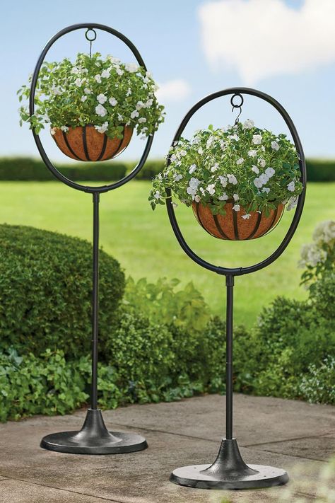 Want to display hanging planter baskets, but have no place to hang them? These freestanding, adjustable height planter displays are the solution. Boxwood Garden, Metal Sculptures Garden, Iron Planters, Hanging Plant Holder, Cloth Store, Grandin Road, Planter Stand, Outdoor Lawn, Room With Plants