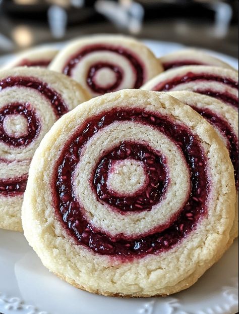 Raspberry Swirl Shortbread Cookies Recipe Cookies With Raspberry Filling, Shortbread Swirl Cookies, Strawberry Pretzel Dessert Cookies, Baking With Raspberry Jam, Raspberry Swirl Shortbread, Short Bread Cookies With Jam, Shortbread Cookie Sandwiches, Cookies With Score Bits, Swirl Cookies Christmas