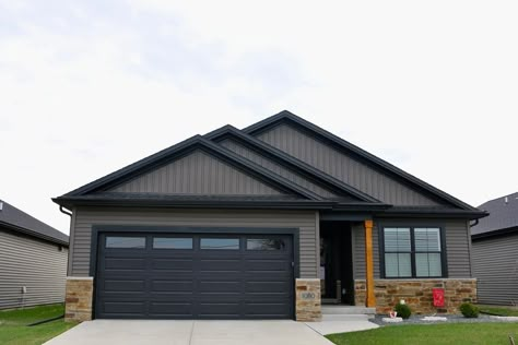 Dark Grey Black Trim Exterior, Dark Gray Black Trim House Exterior, Black House With Black Garage Door, House Siding With Black Windows, Dark Gray Siding Black Garage Door, Black Garage Door Gray House, Brown Siding With Black Trim, Gray With Black Trim House, Tan Siding Black Garage Door