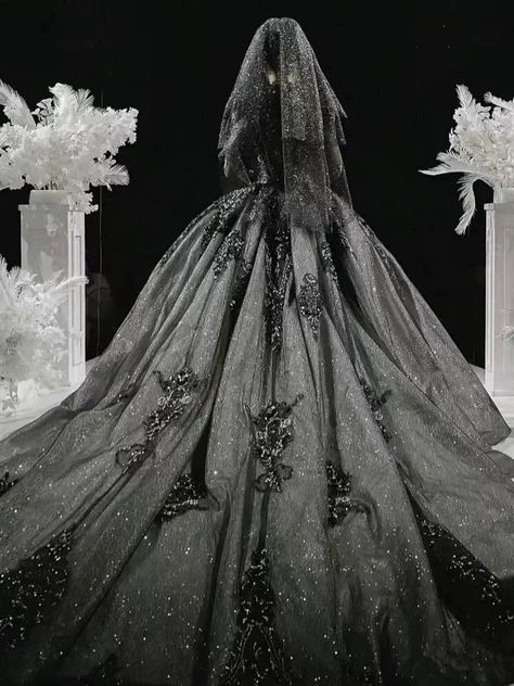 Our Majestic Twilight gown offers a breathtaking fusion of gothic charm and bridal elegance, tailor-made for the plus size bride who covets a unique and opulent look for her wedding day. The dress features a sumptuous silver lace overlay, meticulously adorned with intricate beading and sequins, creating a mesmerizing effect that sparkles with every movement. The bodice, with its refined structure and deep V-neckline, is both flattering and dramatic, leading to delicate cap sleeves that drape ove Black Glittery Wedding Dress, Tim Burton Wedding Dress, Black And Silver Wedding Dress, Majestic Wedding Dresses, Romantic Goth Wedding Dress, Grey Wedding Dress Silver, Space Wedding Dress, Dark Fantasy Wedding Dress, Black Goth Wedding Dress