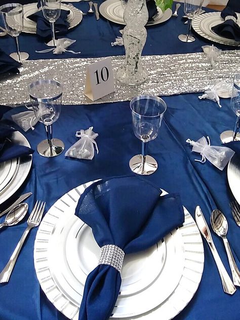 Blue And Silver Tablescapes, Silver Table Settings Ideas, Blue Silver Table Decor, Navy Blue And Silver Table Setting, Navy And Silver Christmas Table, Quince Decorations Navy Blue And Silver, Navy And Silver Wedding Decorations, Navy And Silver Wedding Theme, Blue And Silver Table Decorations