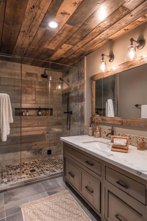 Blend rustic elements like wood and stone with sleek modern fixtures in your bathroom for a cozy yet contemporary feel. Use a wooden vanity, stone accents, and matte black hardware for a chic, modern rustic look. 🛁 Rustic Farmhouse Bathroom Ideas, Pond Building, Modern Farmhouse Bathroom Ideas, Rustic Bathroom Shower, Rustic Bathroom Remodel, Rustic Farmhouse Bathroom, Bathroom Remodel On A Budget, Farmhouse Bathroom Ideas, Cabin Bathroom