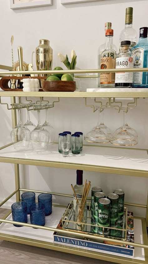 It’s best to choose colors that tie throughout your apartment when designing your bar cart. Bar Cart Colorful, Bar Cart Must Haves, Tequila Bar Cart, College Apartment Bar Cart, Beach Bar Cart, Classy Bar Cart, College Bar Cart, Blue Bar Cart, Apartment Bar Cart