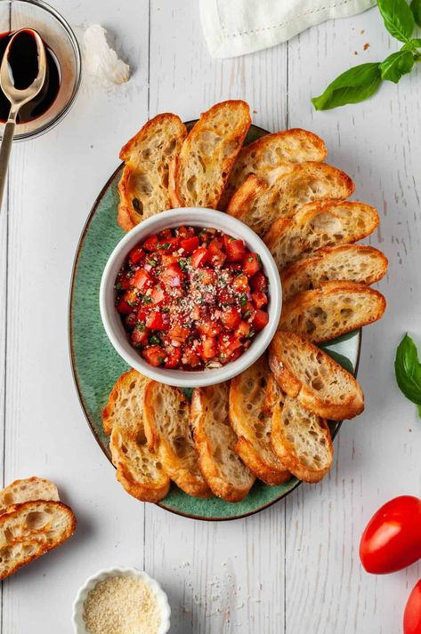 Fresh basil and vine-ripened tomatoes make this classic bruschetta recipe perfect for summer get-togethers! The bread can be toasted in the oven or grilled, and it’s easy to make in advance so you can get a head start on your party prep! | tomato basil bruschetta recipe | bruschetta with tomato and basil | tomato basil bruschetta appetizers | tomato bruschetta with garlic and basil | tomato and basil bruschetta Bruschetta With Tomato And Basil, Tomato And Basil Bruschetta, Italian Canapes Appetizers, Italian Bruschetta Aesthetic, Bruschetta Presentation, Bruschetta Ideas Appetizers, Appetizer Italian Appetizers, Italian Summer Party Food, Guest Snacks Ideas