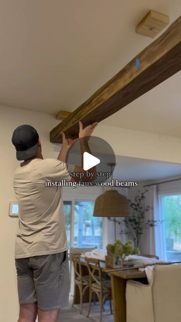 Interiors with Becky on Instagram: "Wooden beams can be a gorgeous addition to a large space like a bedroom or living/dining area. And are fairly cost effective too!   Below are step by step instructions on how to install by @cozyonclayton   The details: Ceilings: 8ft Beam Measurements: 14’L x 6’’W x 4’’H Beam Style: Timber in Antique Brown Number of Beams: 4  Beams from @barrondesigns   1. Order samples! We ordered 6 different colors and textures before picking these. (Every style can look so different depending on the house!)  2. Always order a longer beam than needed. For example- we ordered 14ft beams for our room that is 13.5ft and cut them to size.  3. Measure with a laser level + mark with a chalk line.  4. We cut 4 blocks to the width of beam opening in order to secure the beams to Living Room With Beams On Ceiling, Fake Beams On Ceiling, Fake Beams Ceiling, Beam Opening, Fake Beam, Porch Beams, Casita Ideas, Ranch Makeover, H Beam