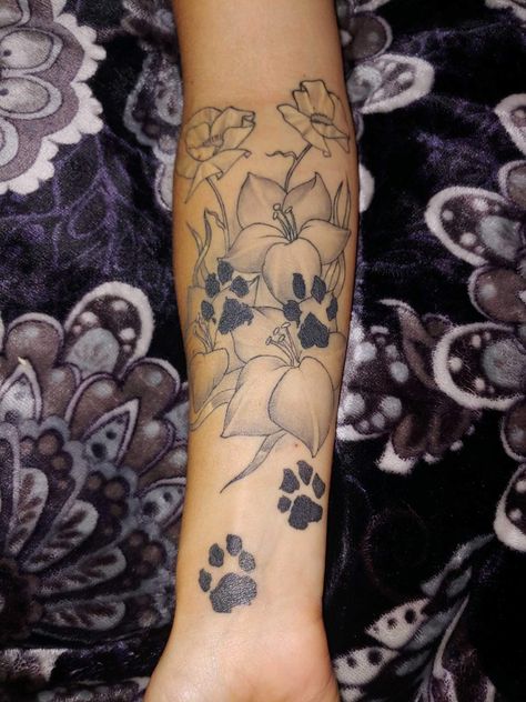 Paw prints with birth flowers. Gladiolus flowers for rememberence and white poppy flowers for condolences. To my Audie, you will always be remembered ♥️ Flowers With Dog Paw Tattoo, Dog Pawprint Tattoo With Flowers, Paw Print In Flower Tattoo, Paw Prints And Flowers Tattoo, Flower Tattoos With Paw Prints, Paw Print With Flowers Tattoo, Dog Paw Print With Flowers Tattoo, Lower Arm Tattoos, Flower Thigh Tattoos