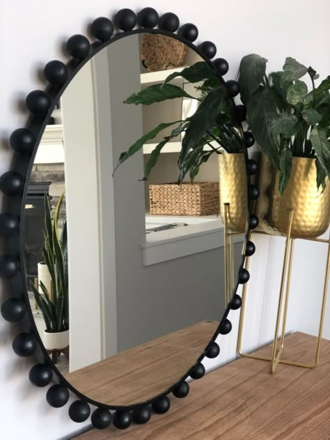 How to get a designer looking mirror for way less cost! I love love love the look of these mirrors but I was positive I could find a way cheaper way to make one on my own. so let’s do this! I started off with this mirror that I found for $58 I absolutely love the size of this one, honestly you can use any round mirror for this project. Next I found these wooden rounds (without holes) I have seen so many people using the wooden round balls with holes in the for projects but the… Round Beaded Mirror, How To Make A Round Mirror Frame, Round Mirror Wall Decor Ideas, Diy Frame For Round Mirror, Oval Wall Decor, Round Mirror Frame Diy, Boho Round Mirror, Round Mirror Decor Ideas, Bead Wall Art