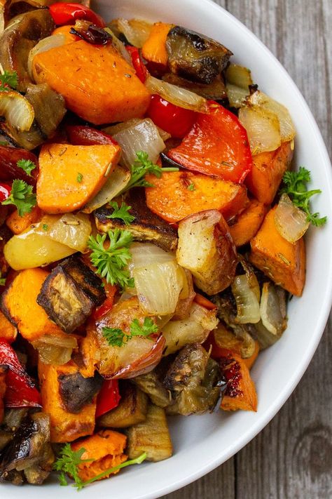 This oven roasted vegetables recipe is simple comfort food. Sweet potatoes, peppers, eggplant, apples and rosemary create a delicious side dish. Not to mention healthy and colorful.  #ovenroastedvegetablesrecipe #bestvegetariansidedishes Potato Recipes Roasted, Roasted Vegetables Recipe, Sweet Potato Recipes Roasted, Oven Vegetables, Roasted Vegetables Oven, Vegetable Recipe, Sweet Potato And Apple, Roasted Vegetable Recipes, Vegetarian Side Dishes