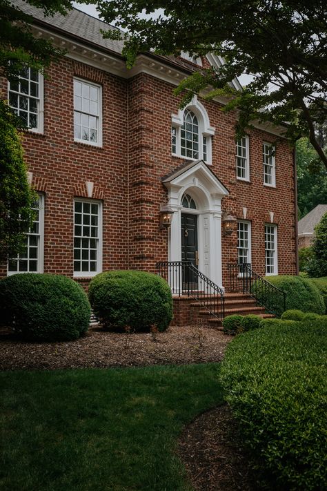 Meet our Colonial home in North Carolina! - Chris Loves Julia Modern Colonial Exterior Brick, Brick Georgian House Exterior, Classic Brick House Exterior, Red Brick Colonial House, English Brick House, Shutters Or No Shutters, Red Brick Colonial House Exterior, Red Brick House Landscaping, Colonial Brick House Exterior