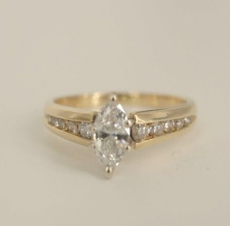 You are bidding on a beautiful 14k yellow gold Marquise Diamond Wedding Ring! This ring is stunning and has one big Marquise cut diamond set in a high setting. This diamond is beautiful and is approximately 0.35ct. There are also ten round cut real diamonds on the side of the marquise that are set in a channel set setting. Those ten diamonds come to approximately 0.20ct. So in total there is approximately 0.65ct of real diamonds in this ring.    The dark spots that can be seen in some of the pic Channel Set Marquise Engagement Rings, Cuts Of Diamond Rings, Not Basic Engagement Rings, Vintage Marquis Engagement Rings, Wedding Rings Real Diamonds, Unique Engagement Rings Non Diamond, Gold Engagement Ring Small Diamond, Vintage Unique Wedding Rings, Women Engagement Rings Gold