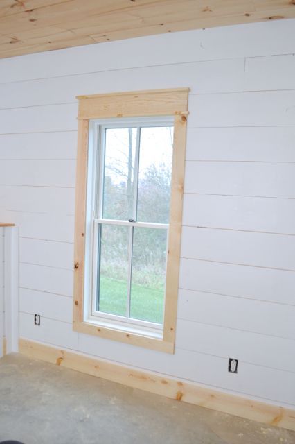 installing DIY shiplap walls and farmhouse trim from wood flooring 1x4 window trim 1x6 baseboards Shiplap Corner Trim, Farmhouse Trim Baseboards, Farmhouse Baseboards, Farmhouse Window Trim, Diy Window Trim, Farmhouse Trim, Interior Window Trim, Shiplap Wall Diy, Baseboard Trim