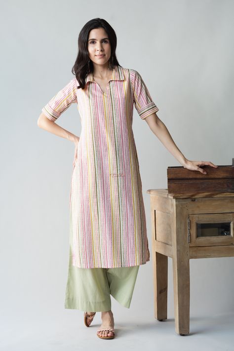 Tailored out of 100% premium cotton, Sabrang is a graceful play of colors to brighten your everyday outfit. The vertical lines of color are sure to add a few inches to your height visually. The collared neckline and elbow sleeves add to the chic beauty of Sabrang. Balance out the colorful playfulness with our neutral pistachio green palazzo. Straight Kurti Designs Cotton, Collar Kurta Designs Women, Kurta Designs Women Casual, Playful Outfits, Stitch Dress, Kurta Women, A Line Kurti, Stylish Kurtis Design, Tie Dye Tops