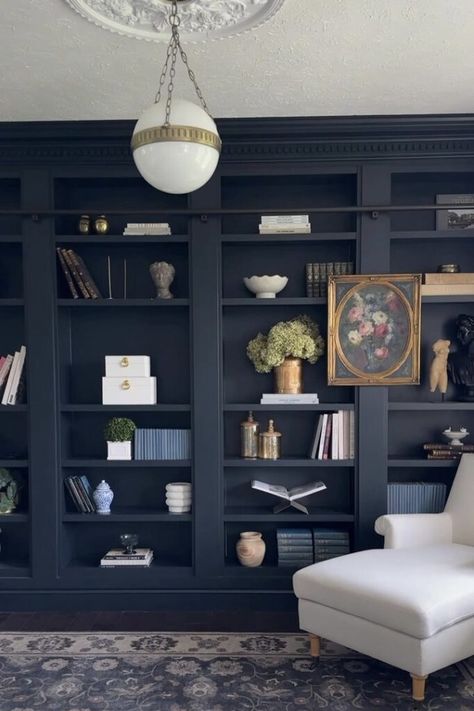 Custom built-ins can be expensive. The DIY Billy bookcase built in hack is a versatile, affordable, and stylish alternative for creating a built-in look! Front Room With Bookshelves, Dark Blue Billy Bookcase, Dark Painted Built In Bookshelves, Dark Blue Built In Bookshelves, Built In Bookshelves Color Ideas, Built In Bookshelves Around Door, Small Space Library Ideas, Painted Bookshelves Built In, Diy Library Wall Bookshelf Ideas